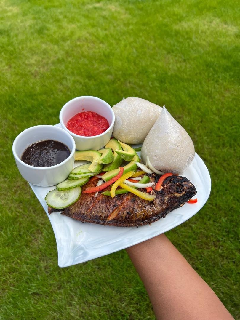 Grilled tilapia served with banku